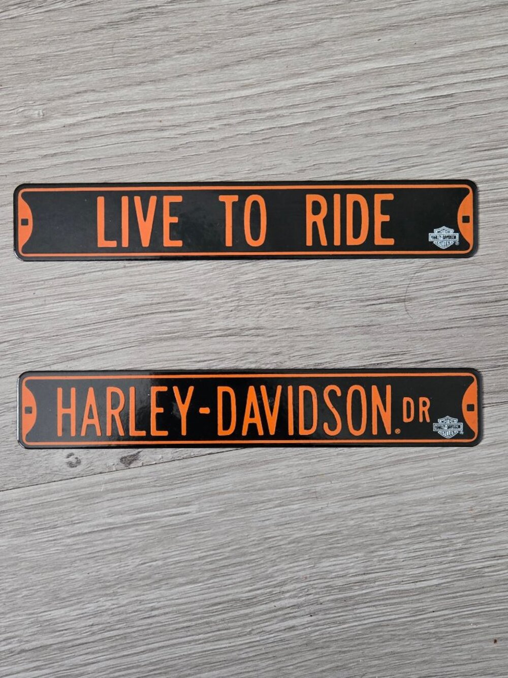 Two mini Harley Davidson signs